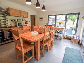 A kitchen with a dining table and chairs at Bracken Ground in Coniston