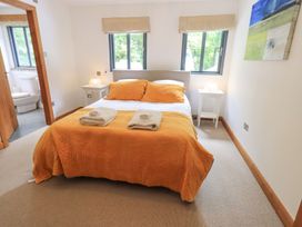 A bedroom with a bed and nightstand at Bracken Ground in Coniston