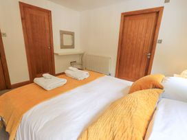 A bedroom with a bed and towels at Bracken Ground in Coniston