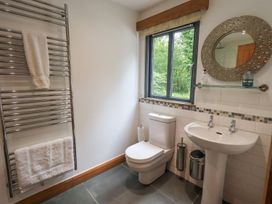 A bathroom with a sink, toilet, towel rail and window at Bracken Ground in Coniston