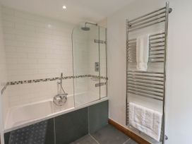 A bathroom with a bathtub and shower at Bracken Ground in Coniston