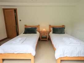 A bedroom with two beds and a nightstand at Bracken Ground in Coniston