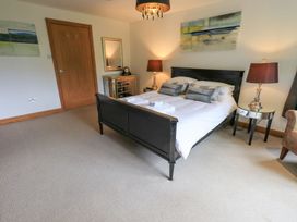 A bedroom with a bed and lamps at Bracken Ground in Coniston