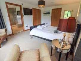 A bedroom with a bed and a television at Bracken Ground in Coniston