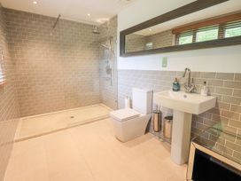 A bathroom with a shower, toilet, and sink at Bracken Ground in Coniston