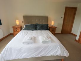 A bedroom with a bed and nightstands at Bracken Ground in Coniston