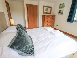 A bedroom with two beds and a wooden dresser at Bracken Ground in Coniston
