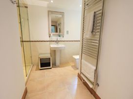 A bathroom with a shower, sink, and toilet at Bracken Ground, Coniston