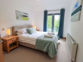A bedroom with a bed and nightstand at Bracken Ground in Coniston
