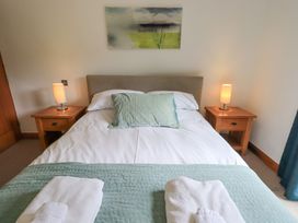 A bedroom with a bed and bedside tables at Bracken Ground in Coniston