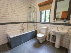 A bathroom with a bathtub, sink, and toilet at Bracken Ground in Coniston