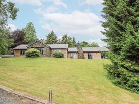 A house with a lawn and trees at Bracken Ground in Coniston
