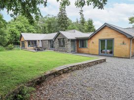 An outdoor view of a property with stone exterior and garden at Bracken Ground in Coniston