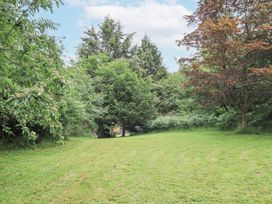 A garden with trees and a grassy area at Bracken Ground in Coniston