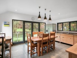 A kitchen with a dining table and fridge at Bracken Ground in Coniston