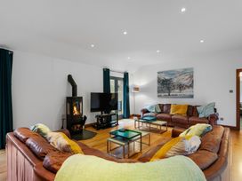 A living room with a sofa and television at Bracken Ground in Coniston