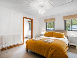 A bedroom with a bed and a chair at Bracken Ground in Coniston