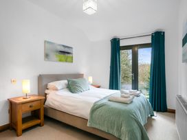 A bedroom with a bed and bedside tables at Bracken Ground in Coniston