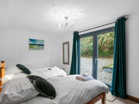 A bedroom with two beds and a window at Bracken Ground in Coniston