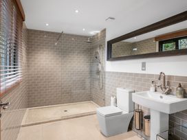A bathroom with a shower, toilet, and sink at Bracken Ground in Coniston