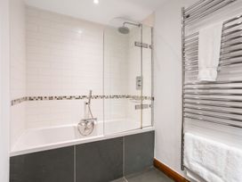 A bathroom with a bathtub and shower at Bracken Ground in Coniston