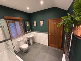 A bathroom with a toilet, sink, and shower at Bracken Ground in Coniston