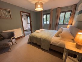 A bedroom with a bed and chair at Bracken Ground in Coniston