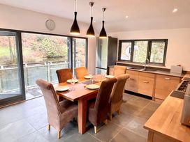 A kitchen with dining table and chairs at Bracken Ground in Coniston