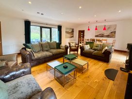 A living room with sofas and a dining table at Bracken Ground in Coniston