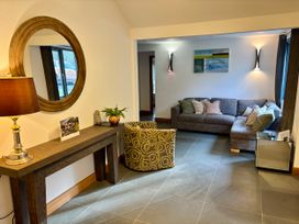 A living room with a sofa and an armchair at Bracken Ground Coniston