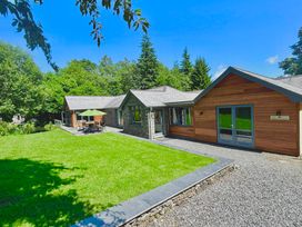 A house with a lawn and outdoor furniture at Bracken Ground in Coniston