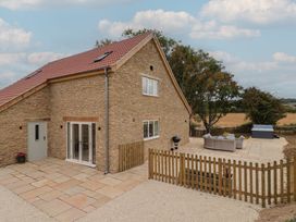 A house with a patio and outdoor furniture at Foxes Den Pendomer near Yeovil Somerset