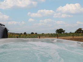 A hot tub with view of sunflower field at Foxes Den Pendomer near Yeovil, Somerset