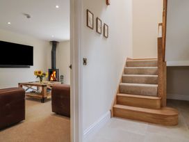 A living room with a television and a fireplace at Foxes Den in Pendomer near Yeovil, Somerset