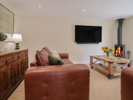 A living room with a sofa and a coffee table at Foxes Den in Pendomer near Yeovil, Somerset