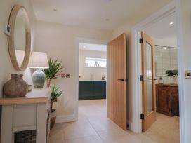 A hallway with a console table and a mirror at Foxes Den in Pendomer near Yeovil, Somerset