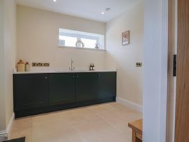 A kitchen with cabinets and a sink at Foxes Den in Pendomer near Yeovil, Somerset
