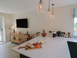 A kitchen with a counter and a wooden cabinet at Foxes Den in Pendomer near Yeovil, Somerset