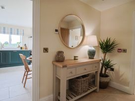 A hallway with a console table and lamp at Foxes Den in Pendomer near Yeovil, Somerset