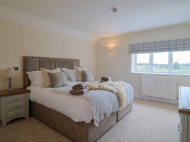 A bedroom with a bed and window at Foxes Den in Pendomer near Yeovil, Somerset