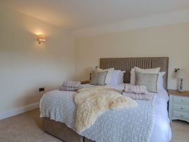 A bedroom with a bed and bedside tables at Foxes Den in Pendomer near Yeovil, Somerset