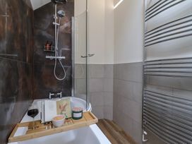 A bathtub with shower and accessories at Foxes Den in Pendomer near Yeovil, Somerset