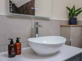 A sink with soap dispensers in a bathroom at Foxes Den in Pendomer near Yeovil, Somerset