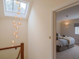 A bedroom with a bed and window at Foxes Den Pendomer near Yeovil, Somerset