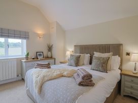 A bedroom with a bed and bedside tables at Foxes Den, Pendomer near Yeovil, Somerset