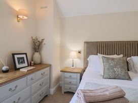 A bedroom with a bed and nightstand at Foxes Den Pendomer near Yeovil, Somerset