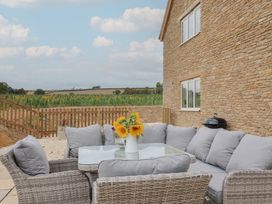 An outdoor seating area with a table and chairs at Foxes Den Pendomer near Yeovil, Somerset