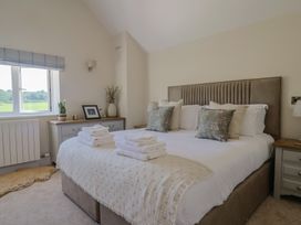 A bedroom with a bed and bedside tables at The Fox Den East Coker