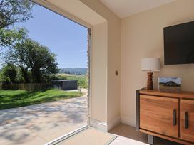 A living room with a view of the garden at The Fox Den in East Coker