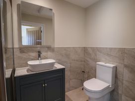 A bathroom with a sink and toilet at The Fox Den in East Coker